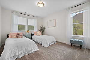 Bedroom with visible vents, carpet floors, and baseboards