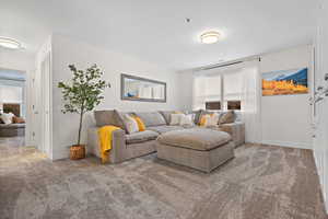 Carpeted living room with baseboards