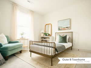 Carpeted bedroom with visible vents and baseboards