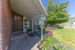 Property entrance with brick siding and a mountain view