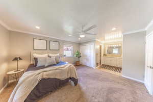 Bedroom with baseboards, recessed lighting, multiple windows, and light carpet