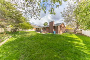 View of yard featuring a fenced backyard and a patio area