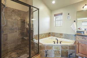 Full bathroom with a garden tub, a stall shower, and vanity