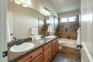 Full bathroom featuring a sink, toilet, double vanity, and visible vents