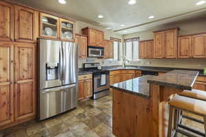 Kitchen featuring a sink, recessed lighting, stainless steel appliances, and brown cabinets