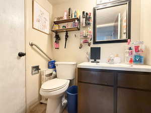 Bathroom featuring vanity, tile patterned flooring, and toilet