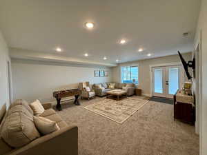Living area featuring recessed lighting, light carpet, and French doors