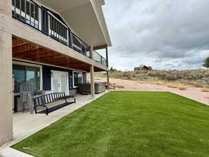 View of yard with a hot tub, french doors, and a patio area
