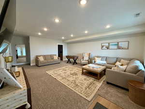 Living room featuring carpet floors, recessed lighting