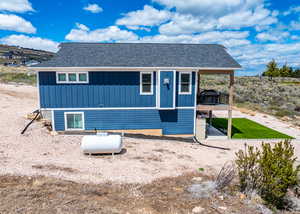 Exterior space featuring roof with shingles and board and batten siding