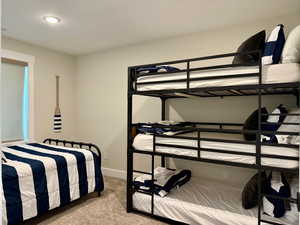 Bedroom featuring carpet floors and baseboards