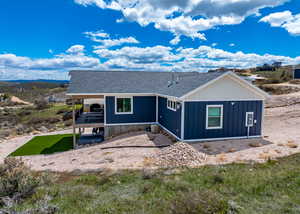 View of front of property featuring board and batten siding and roof with shingles