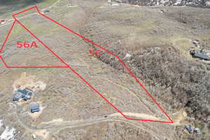 Birds eye view of property with view of desert and a rural view