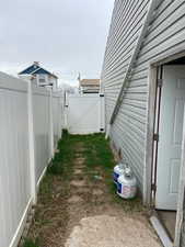 View of side yard with fully fenced in area.