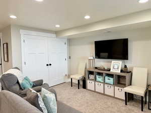 Carpeted living area featuring recessed lighting