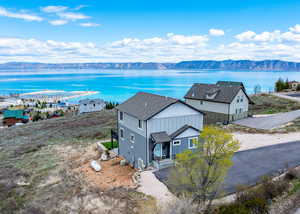 Drone / aerial view featuring a water and mountain view