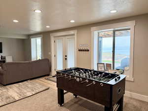 Rec room featuring french doors, recessed lighting, and a textured ceiling