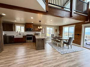 Kitchen featuring a sink, appliances with stainless steel finishes, light wood-style floors, and recessed lighting