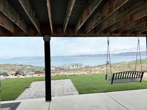 View of patio / terrace with a water and mountain view