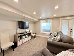 Living area featuring visible vents, recessed lighting, french doors, and carpet