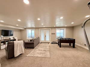 Game room featuring recessed lighting, carpet flooring, a healthy amount of sunlight, and french doors