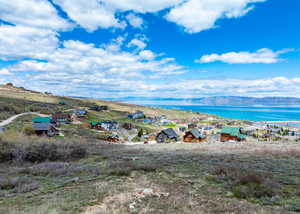Birds eye view of property featuring a water and mountain view