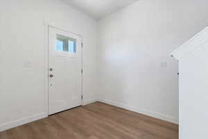 Foyer entrance featuring baseboards and wood finished floors