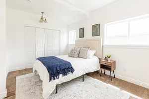 Carpeted bedroom featuring baseboards and a closet