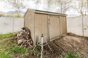 View of shed with a mountain view and a fenced backyard
