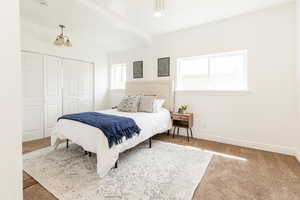 Bedroom with baseboards, a closet, and carpet