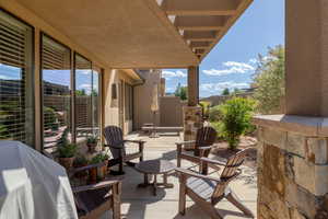View of patio with fence and grilling area