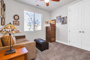 Sitting room featuring baseboards, ceiling fan, carpet, and visible vents