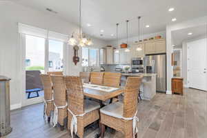Dining space featuring tiled floor, visible vents, baseboards, a chandelier, and recessed lighting