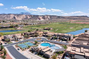Birds eye view of property with golf course view and a water and mountain view