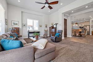Living area featuring baseboards, ceiling fan, light carpet, and recessed lighting