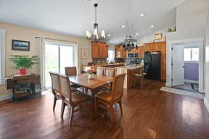 Dining area featuring recessed lighting, baseboards, a chandelier, and dark wood-type flooring