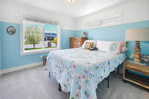 Bedroom with crown molding, carpet flooring, and baseboards