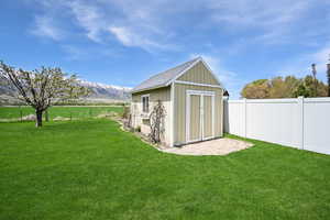 View of shed featuring a mountain view and a fenced backyard