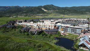 Drone / aerial view featuring a water and mountain view