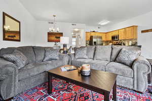 Living area with visible vents and an inviting chandelier