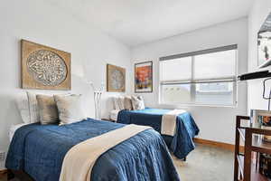 Carpeted bedroom featuring baseboards