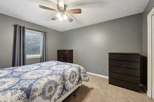 Bedroom featuring baseboards, carpet, and a ceiling fan