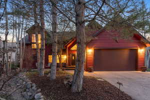 View of front of home featuring an attached garage and concrete driveway