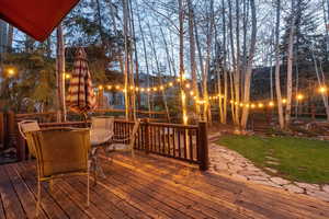 Deck featuring outdoor dining area and a yard
