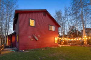 View of side of home featuring a lawn