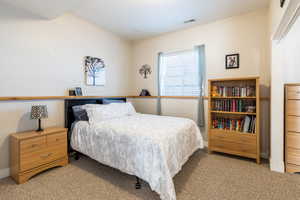 Bedroom featuring baseboards and light carpet