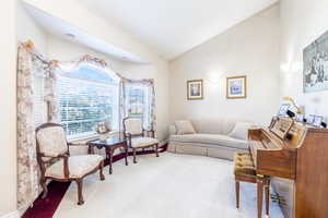 Living room featuring lofted ceiling and carpet