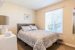 Bedroom featuring baseboards and carpet
