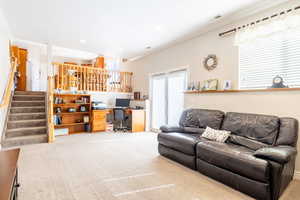 Living area featuring carpet floors, ornamental molding, visible vents, stairway, and recessed lighting