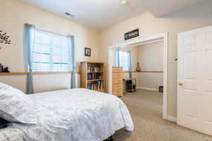 Bedroom with baseboards, light colored carpet, and visible vents